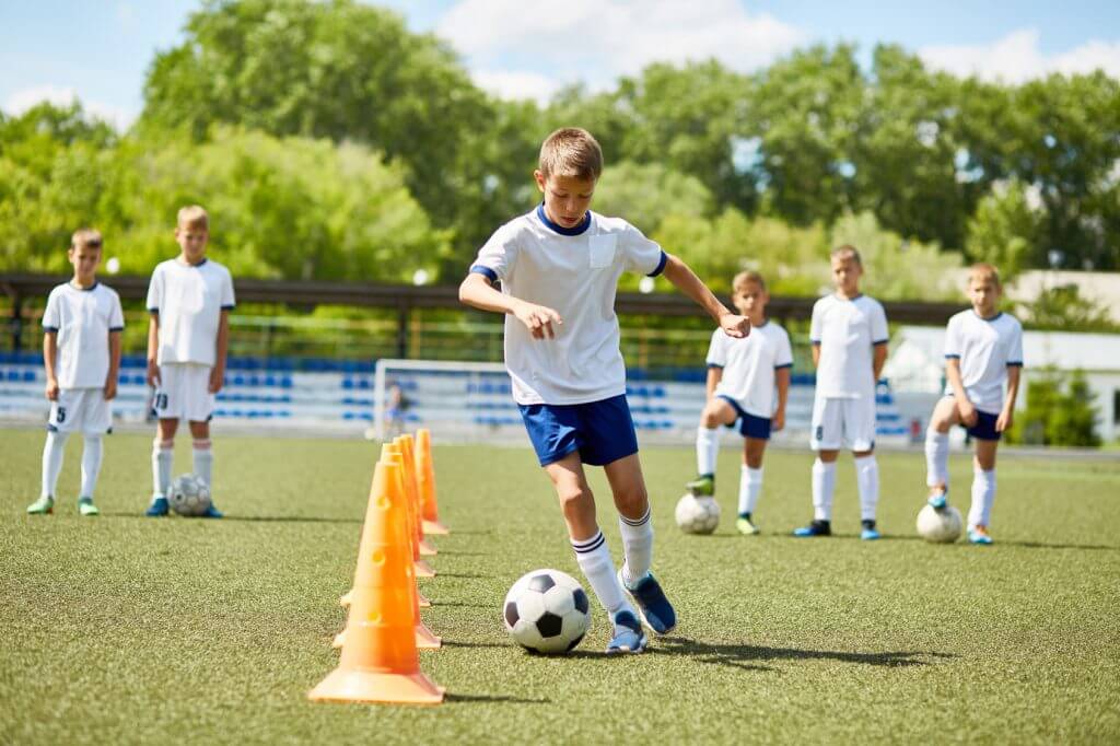 Boys on a football sports tour praticing with a ball