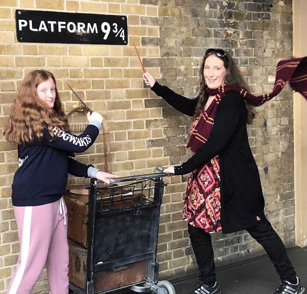 Mother and daughter with baggage trolley at Harry Potter's Platform 9 3/4