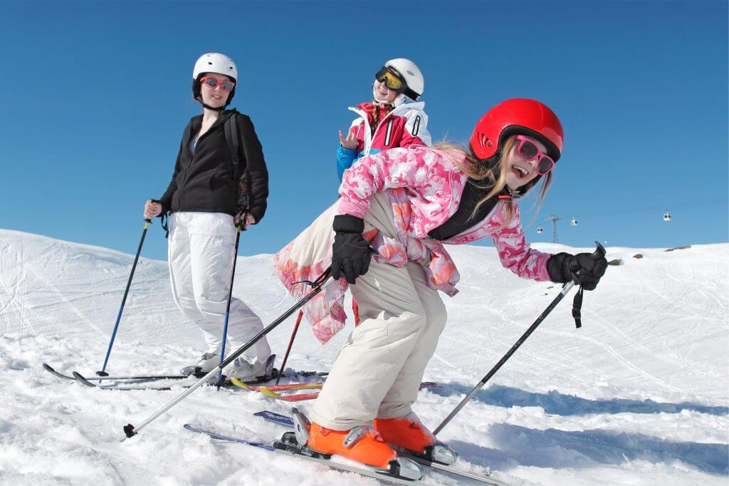 Three girls on a ski tour in the snow