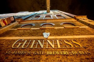 The facade of the Guinness Storehouse illuminated at night