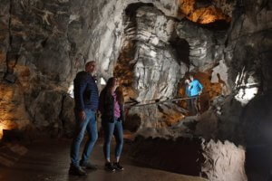 A couple in a cave at the National Showcaves Centre in Wales