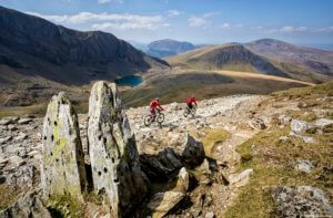 Two mountain bikers riding a stoney path at Llanberis