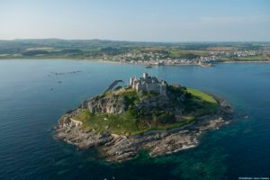 St Michaels Mount, a historic fortified building on a rocky outcrop in the Marazion bay, off the coast of Cornwall. Aerial view.